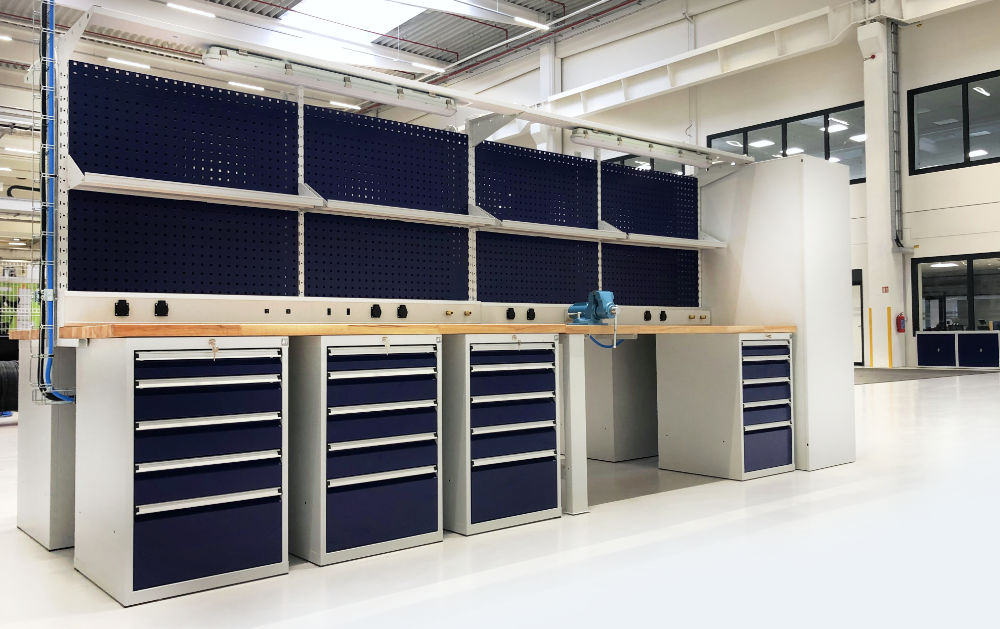 Workshop workbenches of the PROFI model line with drawer containers, electric power bus ducts and extensions