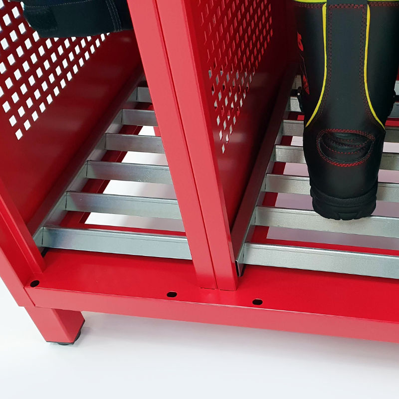 The bottom of the locker with a cut-out and galvanized grates for firefighter boots