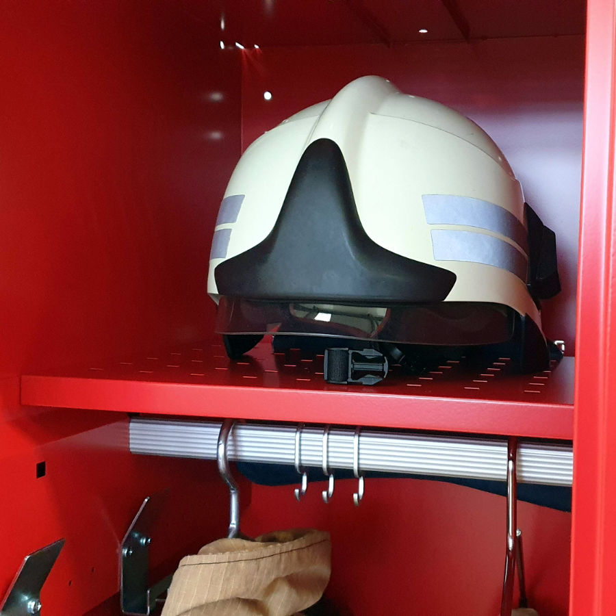 Perforated storage shelf for fireman's helmet