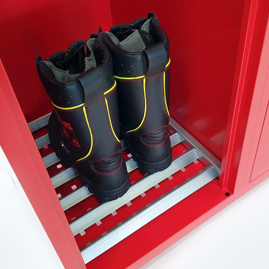 Perforated bottom of the firefighter locker with a grate for storing firefighter boots